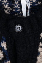 Dior knit cardigan close-up: black button and navy/cream logo knit pattern.