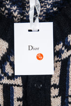 Dior knit cardigan with navy and cream geometric logo pattern, hanging tag visible.
