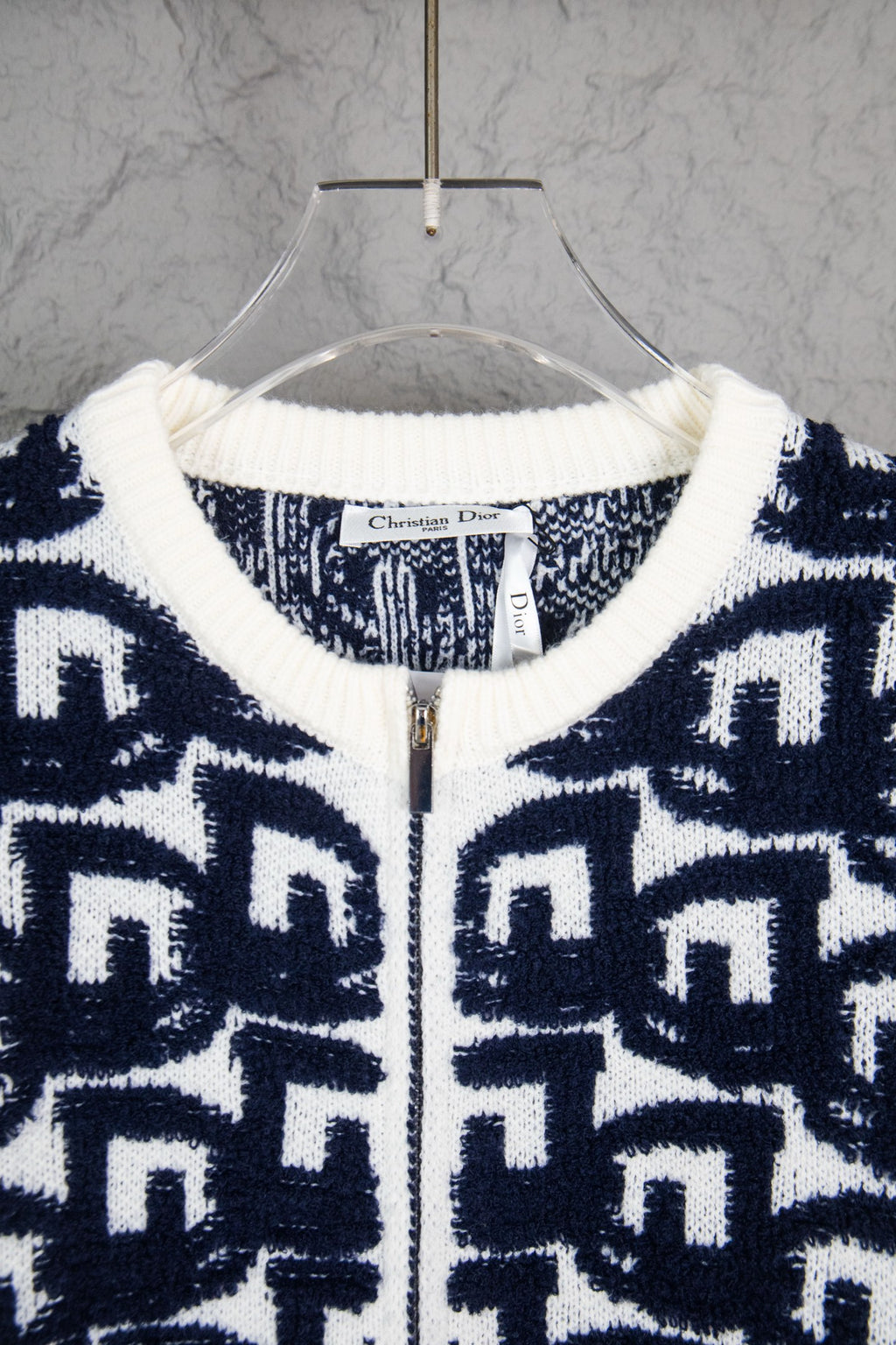 Navy-and-white knit sweater neckline with ribbed trim and zip front, Dior tag.