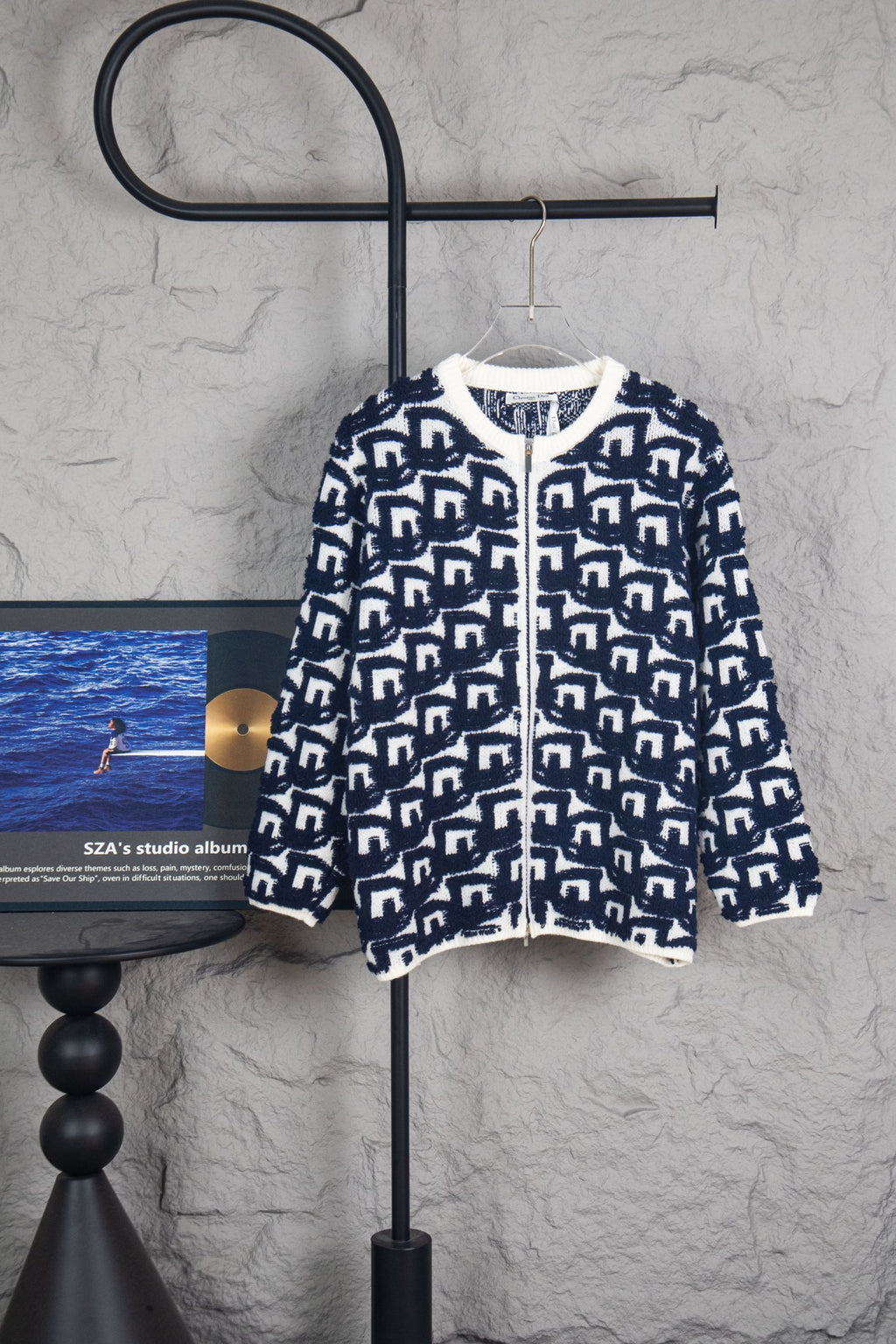 Long knit sweater with navy-and-white geometric Dior logo pattern, zip front.