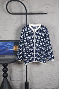 Long knit sweater with navy-and-white geometric Dior logo pattern, zip front.
