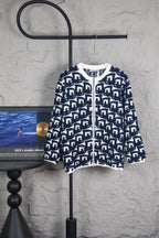 Long knit sweater with navy-and-white geometric Dior logo pattern, zip front.