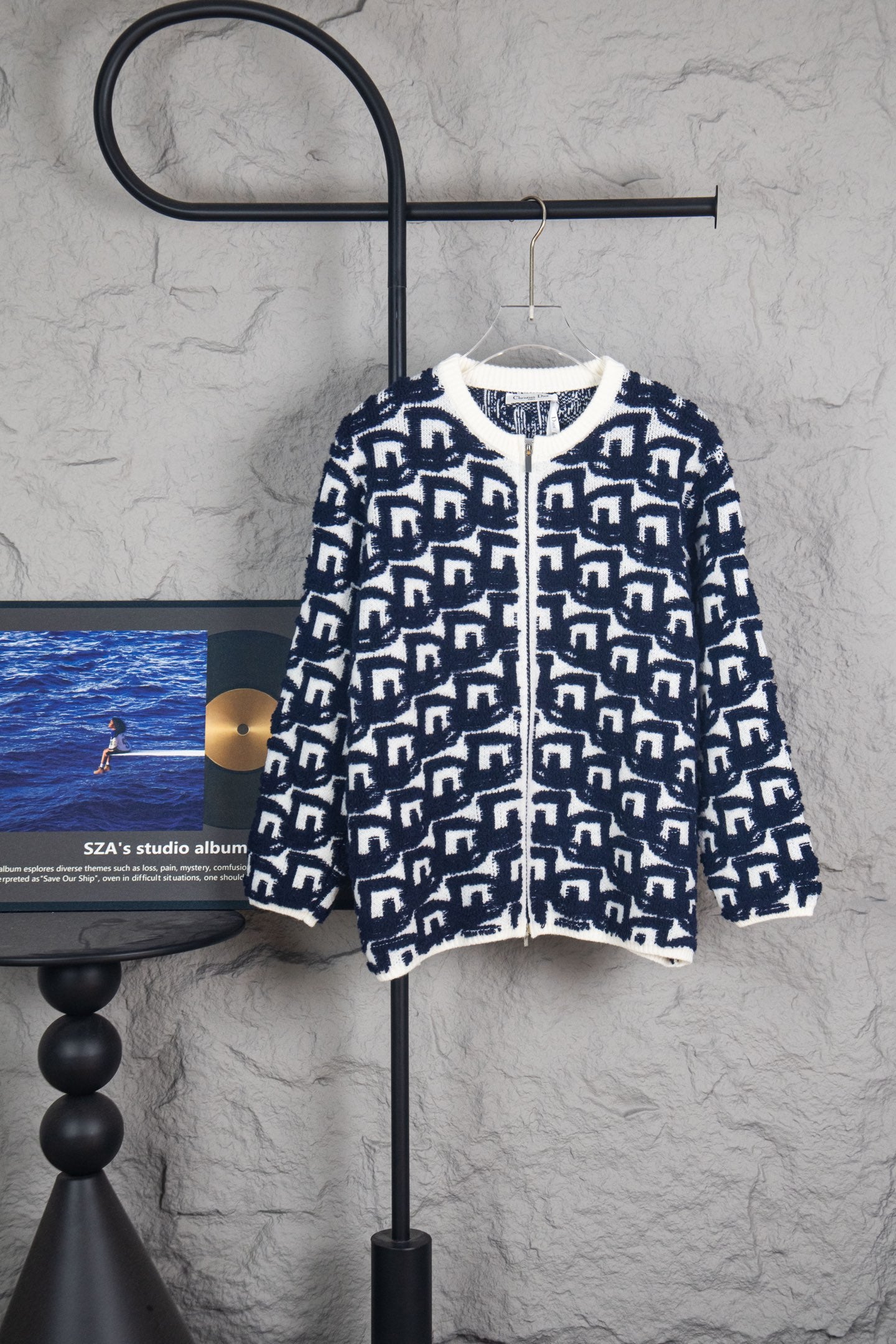 Long knit sweater with navy-and-white geometric Dior logo pattern, zip front.