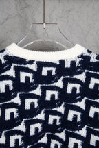 Back of navy-and-white knit sweater with repeating Dior motifs pattern.