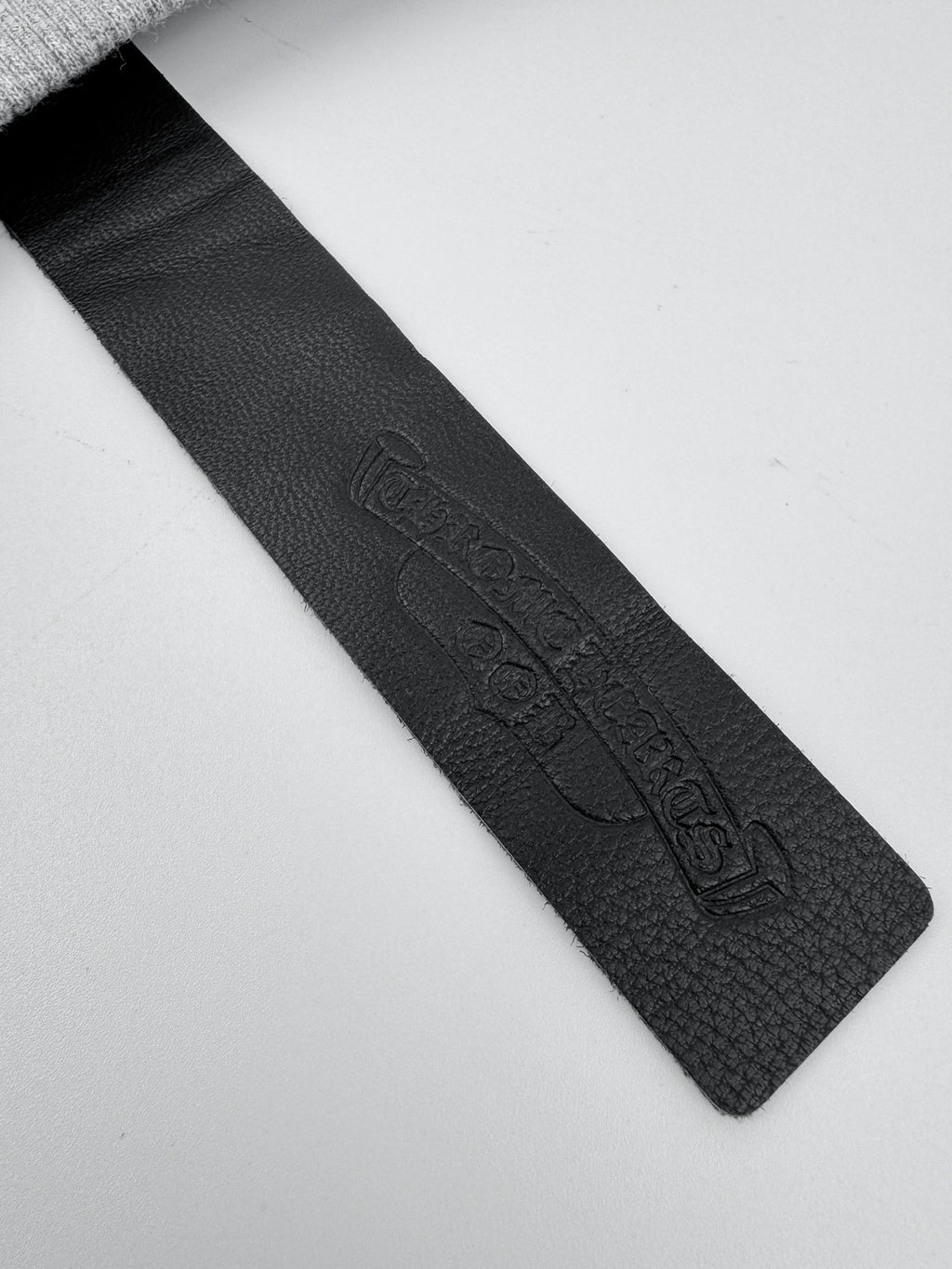 Black fabric neck label stitched inside heather gray sweatshirt collar