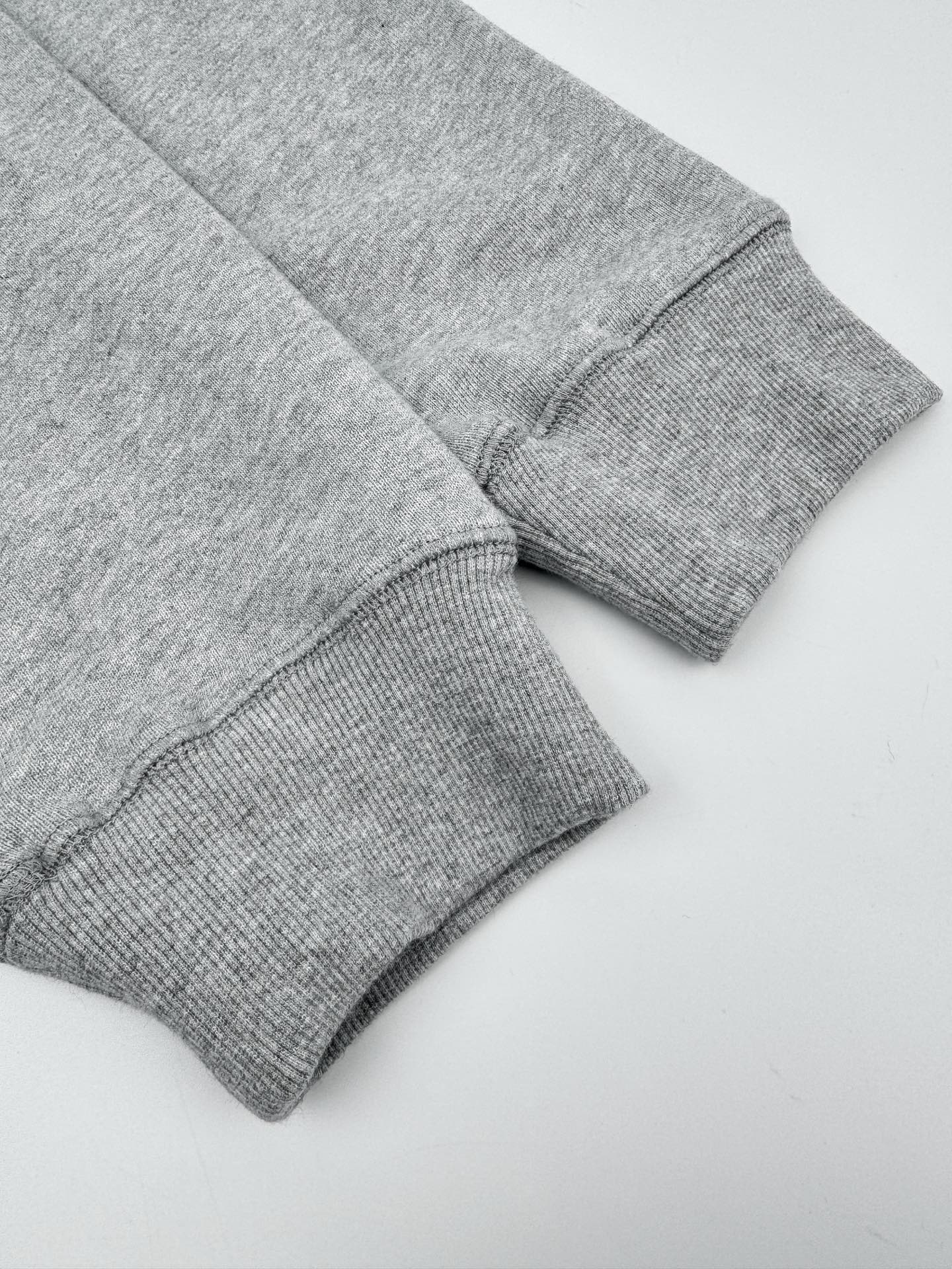 Heather gray sweatshirt sleeve cuffs with ribbed knit hem