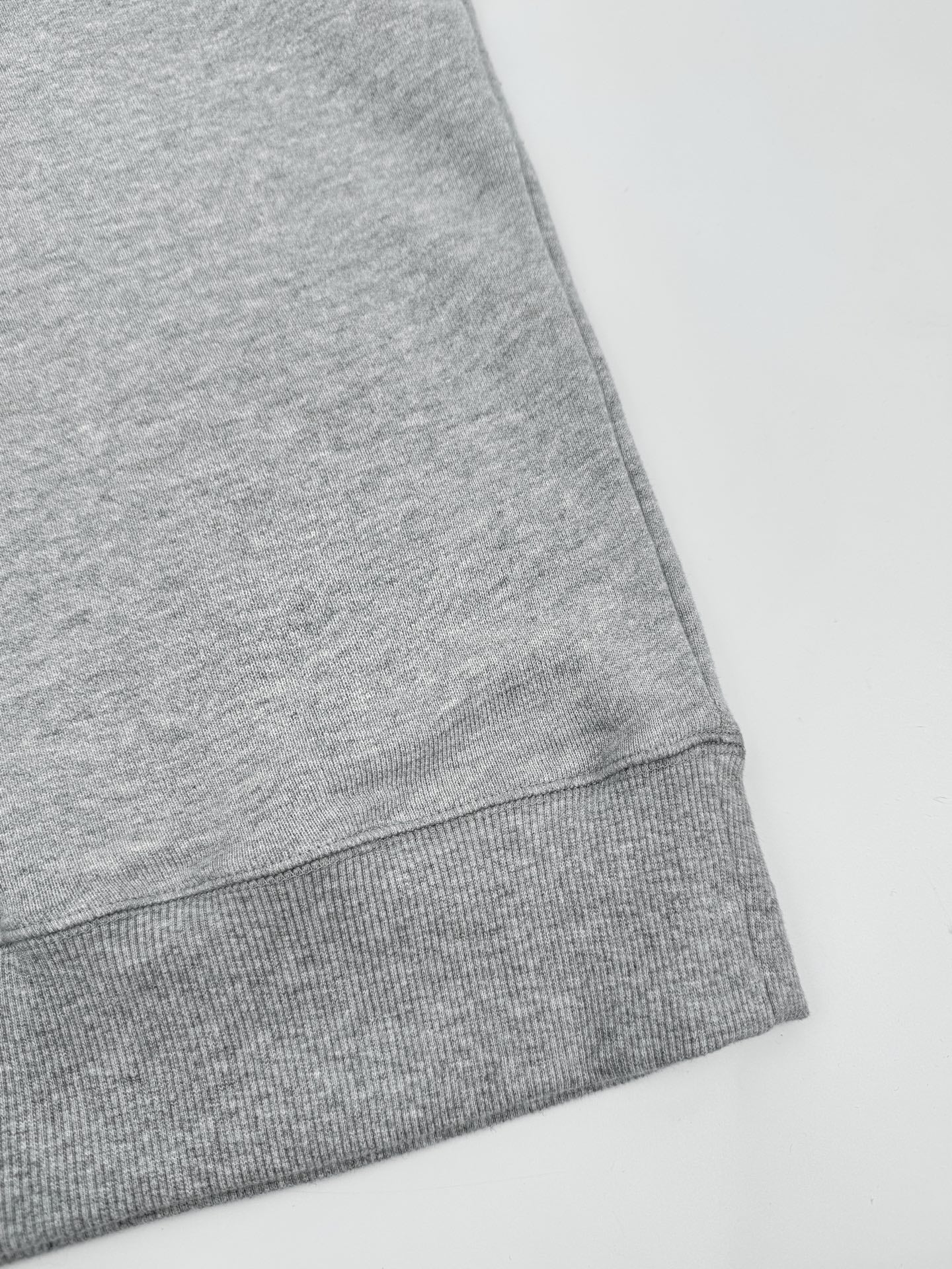 Heather gray sweatshirt hem with ribbed bottom band