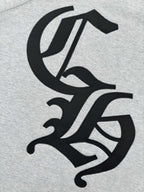 Black stylized emblem graphic on heather gray sweatshirt front