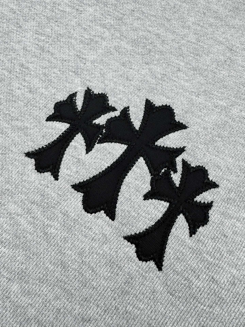 Black leaf-style graphic on heather gray sweatshirt front