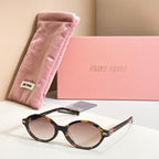 MiuMiu round sunglasses with dark tortoise frame and amber tinted lenses