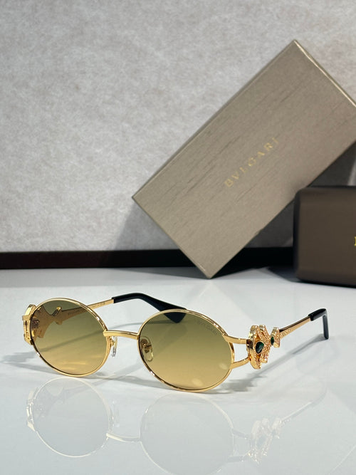 Round sunglasses with gold frame and yellow tinted lenses