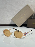 Round sunglasses with gold frame and light amber tinted lenses