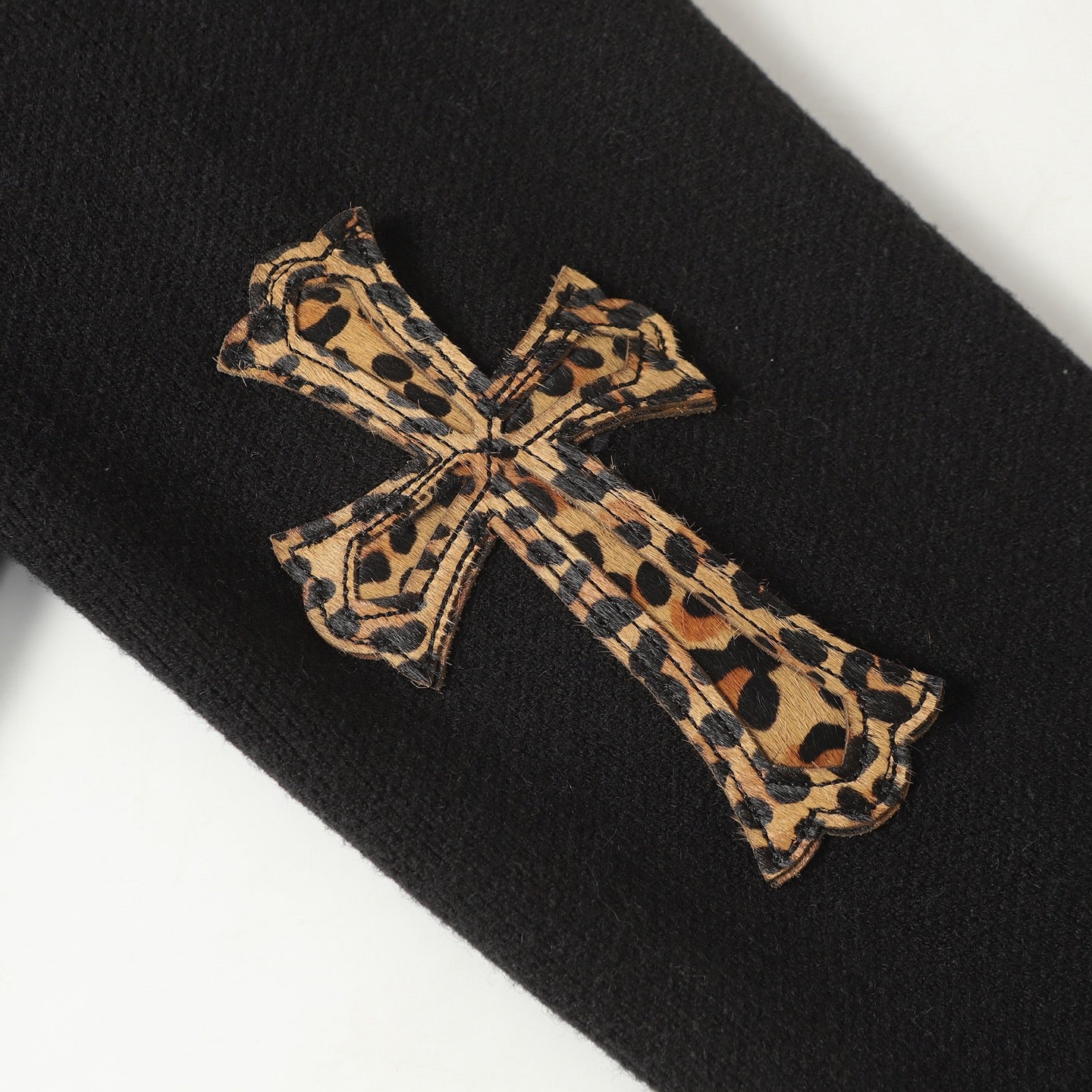 Leopard print bow applique on black jacket sleeve