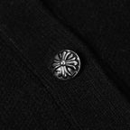 Silver flower-pattern button on black jacket