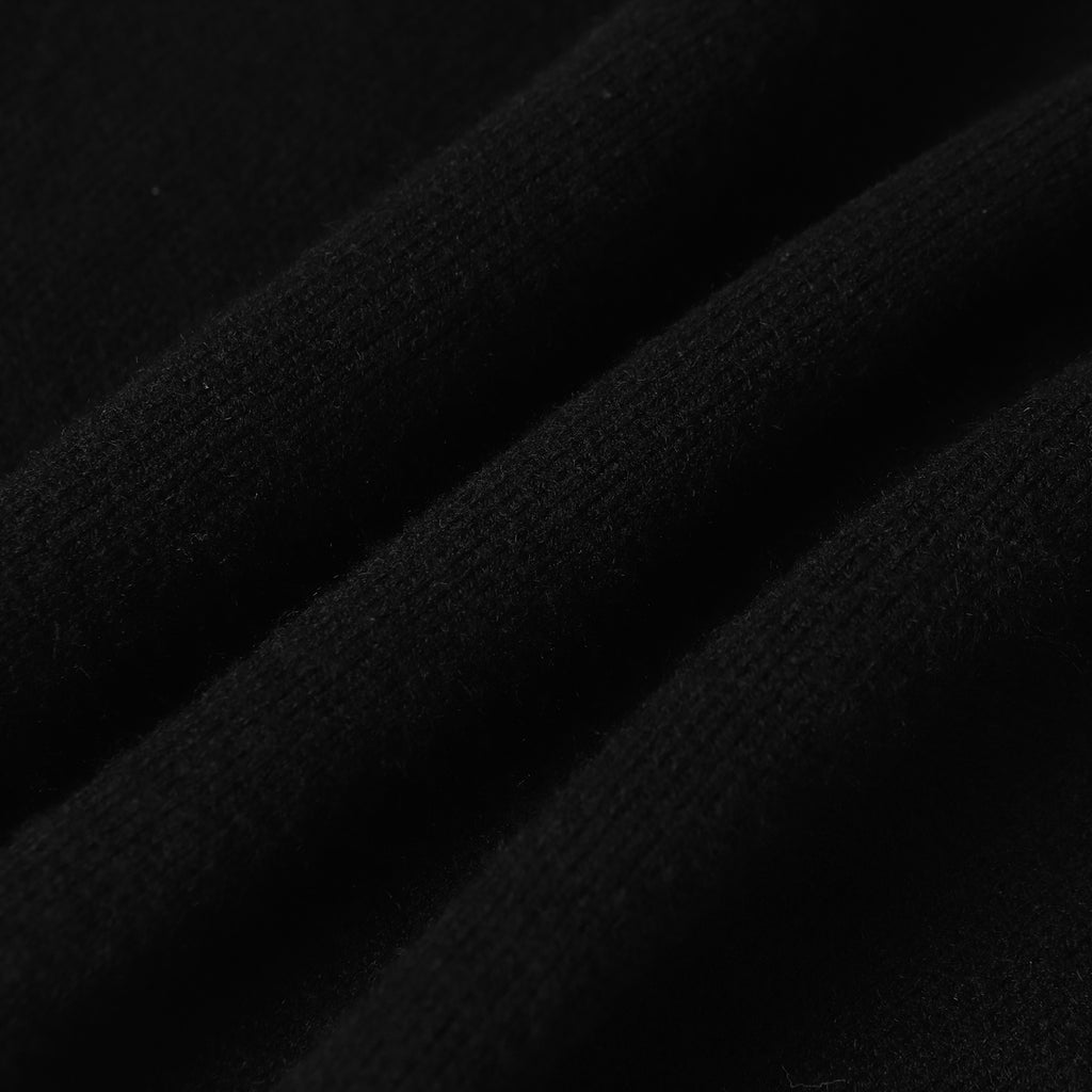 Dark knit fabric close-up with fine textured weave