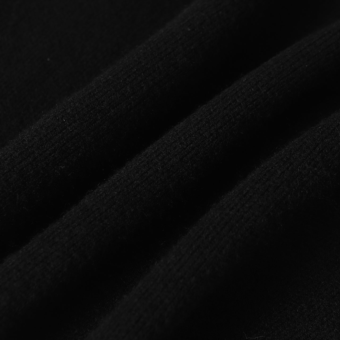 Dark knit fabric close-up with fine textured weave
