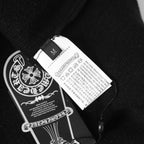 Black jacket care label and brand patch on interior