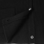 Black jacket front seam with silver flower button