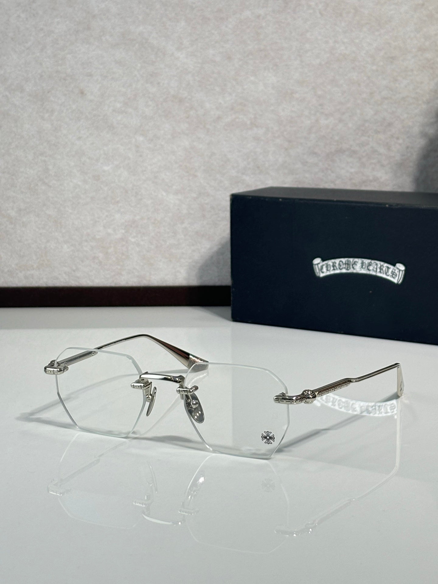 Chrome metal eyeglasses with clear lenses and thin gold wire arms
