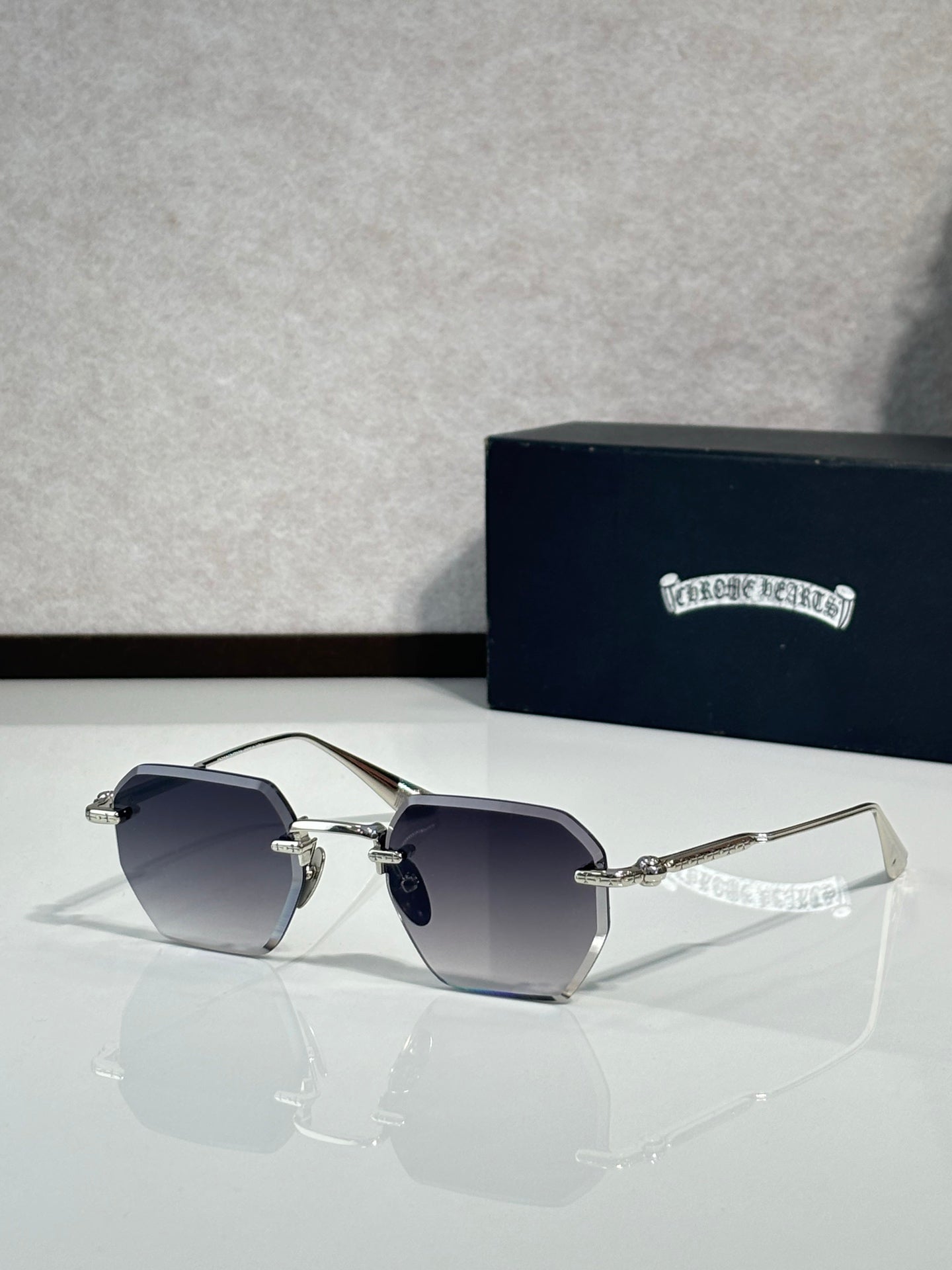 Chrome metal sunglasses with gradient dark lenses and thin gold arms