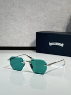 Chrome metal sunglasses with teal tinted lenses and gold-toned frame temples