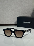 Sunglasses with black frames and taupe-tinted lenses, metal hinge detail on temples