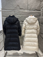 Hooded long Moncler puffer coat in dark color, quilted with front zipper