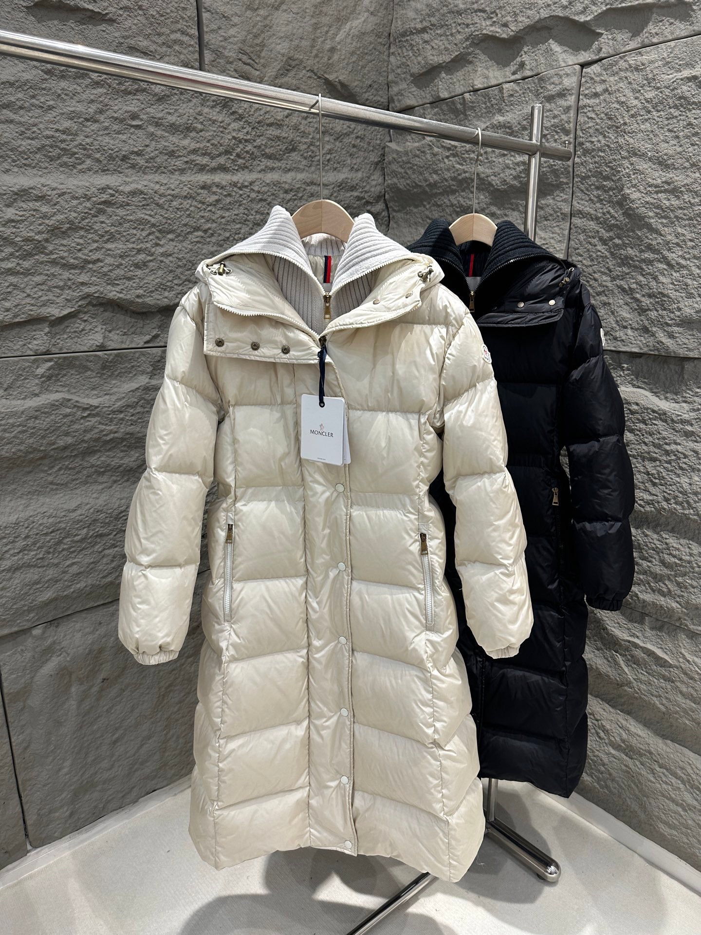 Cream Moncler long puffer coat with hood, front zipper, and quilted texture