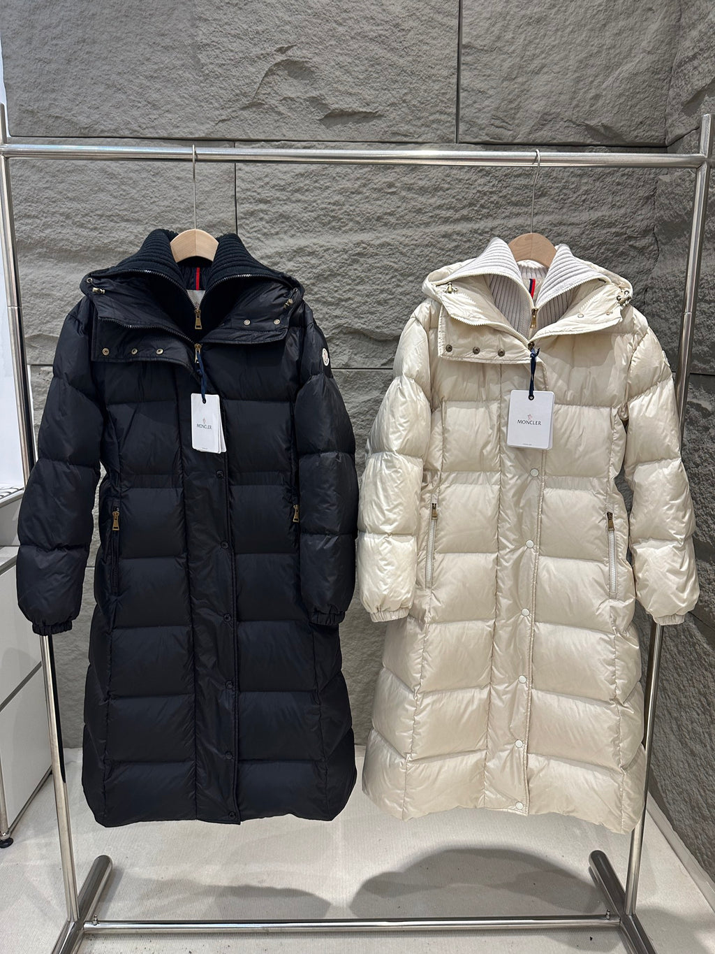 Long Moncler puffer coat with hood, front zipper, and quilted panels