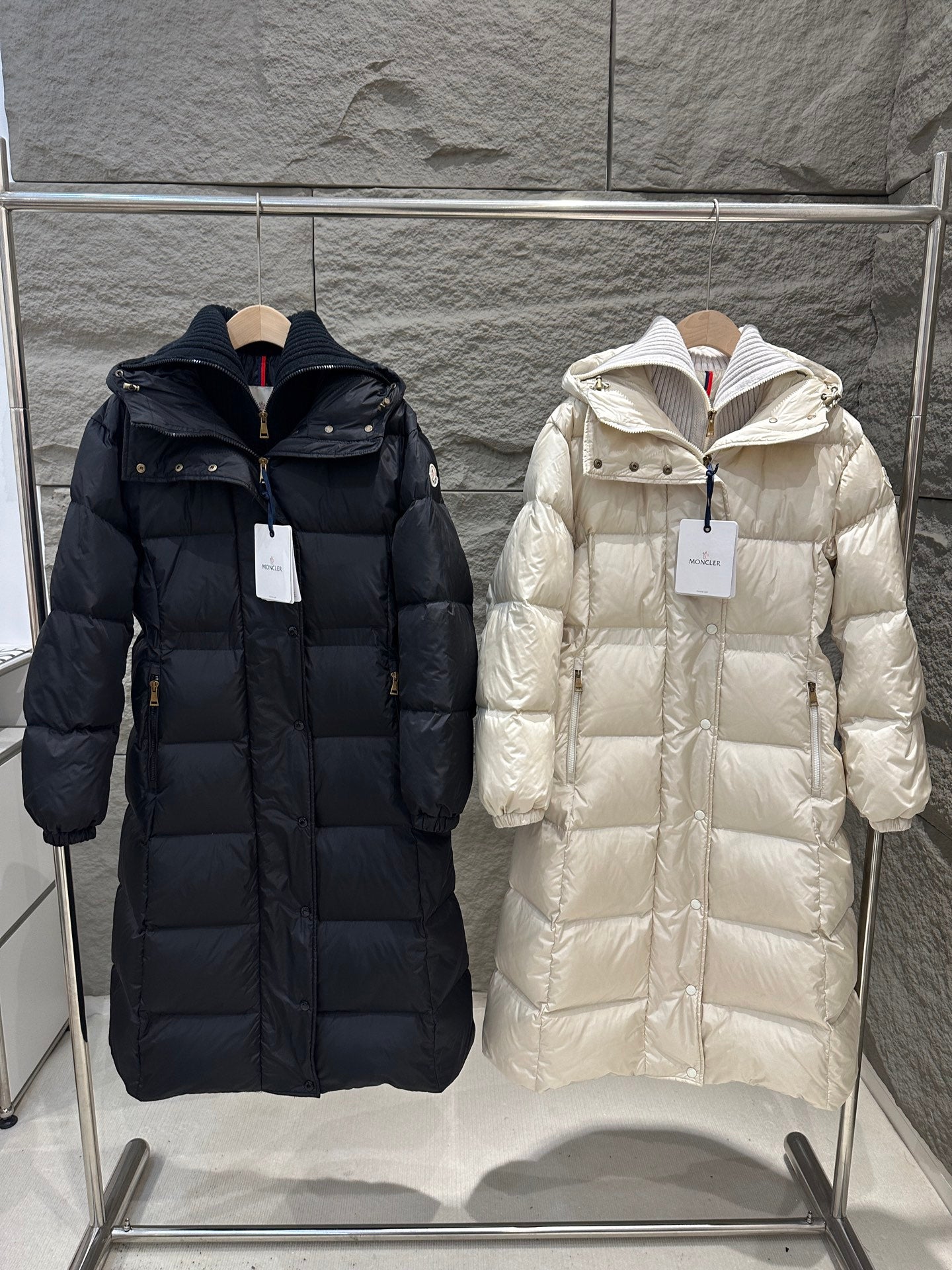 Long Moncler puffer coat with hood, front zipper, and quilted panels