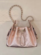 Chanel quilted top-handle handbag with chain strap, rose-pink leather, logo medallion