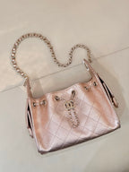 Chanel quilted handbag with chain strap, rose-pink leather, side profile and dangling pull