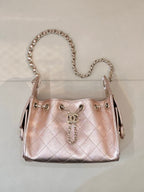 Chanel quilted handbag with chain strap, rose-pink leather, front logo charm and rings