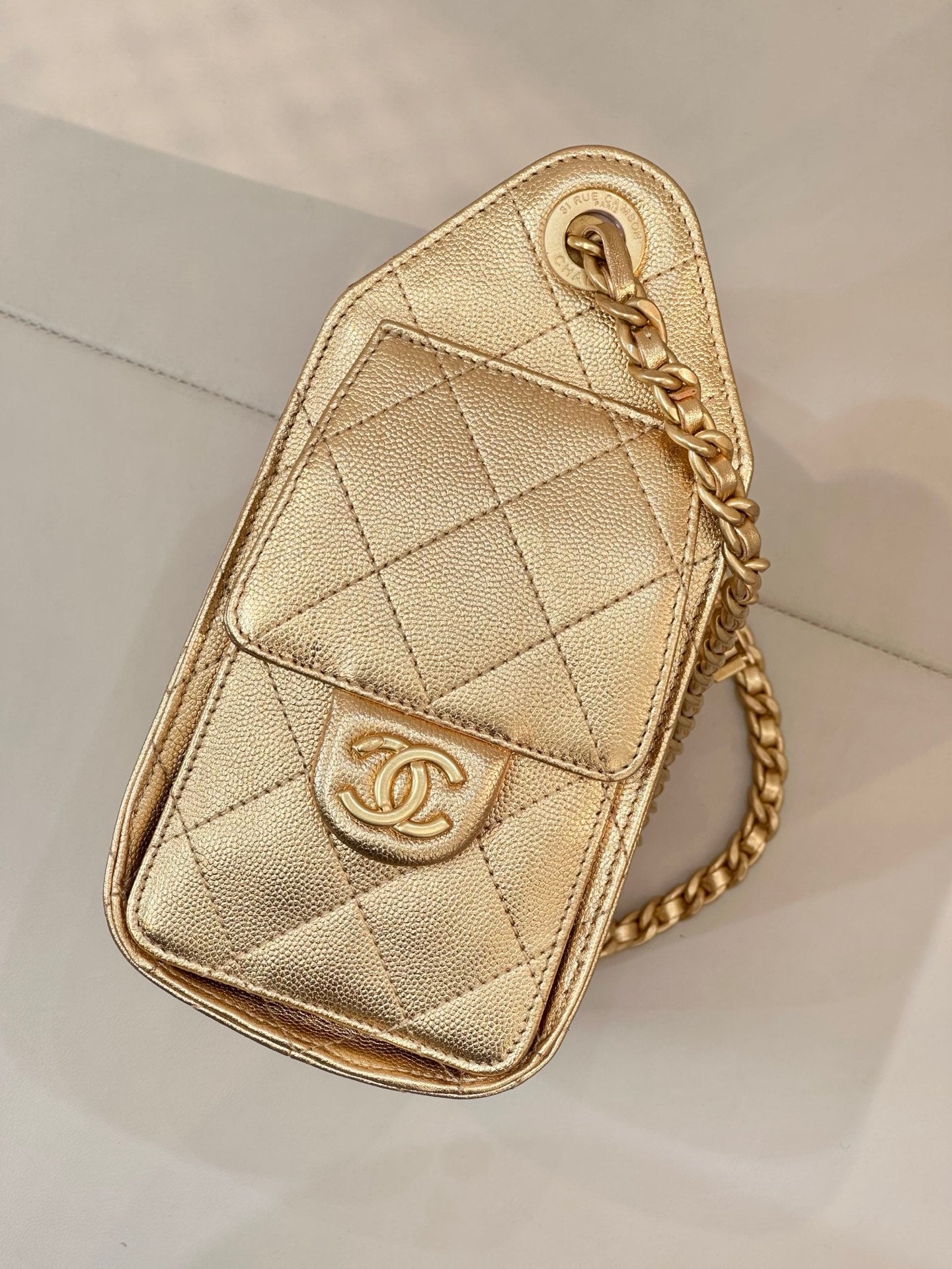 Chanel quilted gold pouch with chain strap and CC-style logo on front