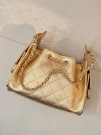Chanel quilted gold handbag with twisted chain strap and side pull tabs