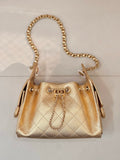 Chanel quilted gold handbag with gold chain shoulder strap and top handles