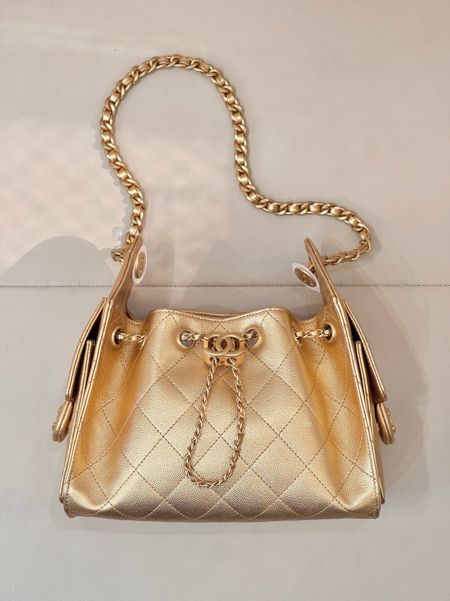 Chanel quilted gold handbag with gold chain shoulder strap and top handles