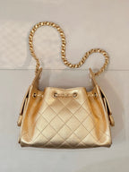 Chanel quilted gold handbag with double chain handle and side clasp hardware