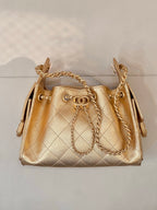 Chanel quilted gold mini handbag with gold chain strap and top hardware detail