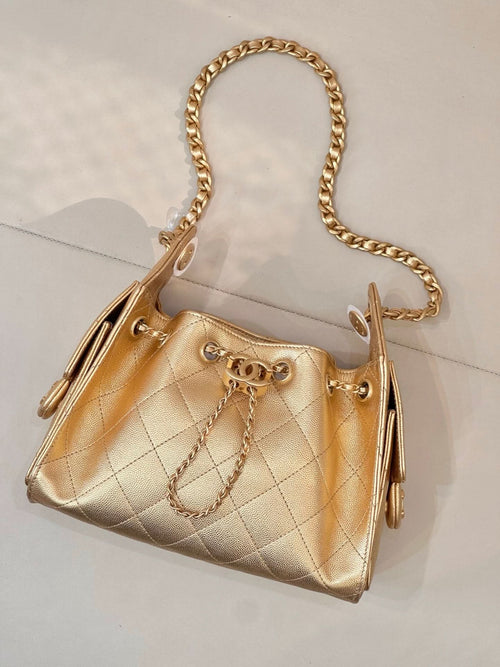 Chanel quilted gold handbag with chain strap, ring clasp front, side pull details