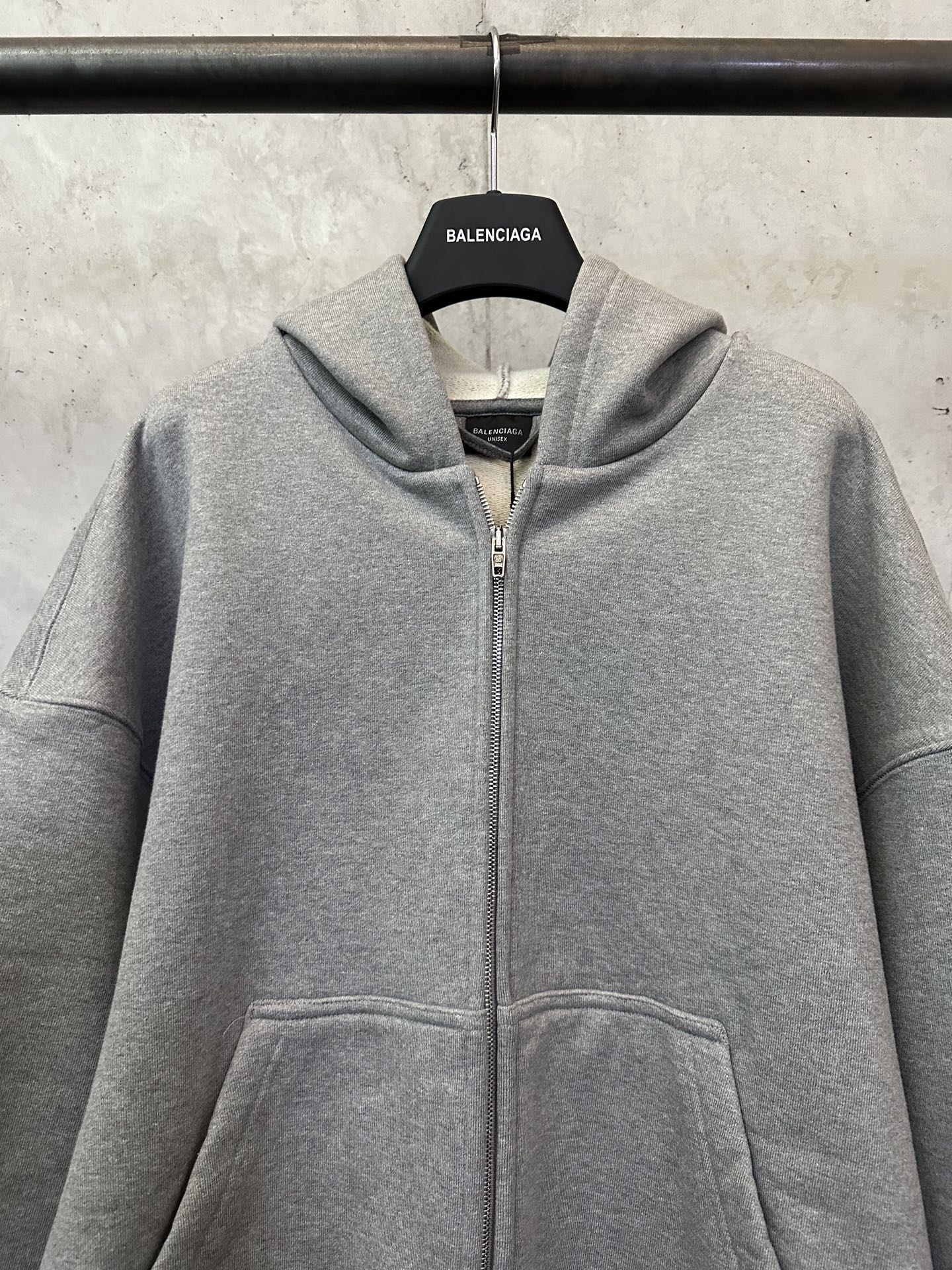 Balenciaga grey zip-up hoodie with hood, front zipper, and kangaroo pocket
