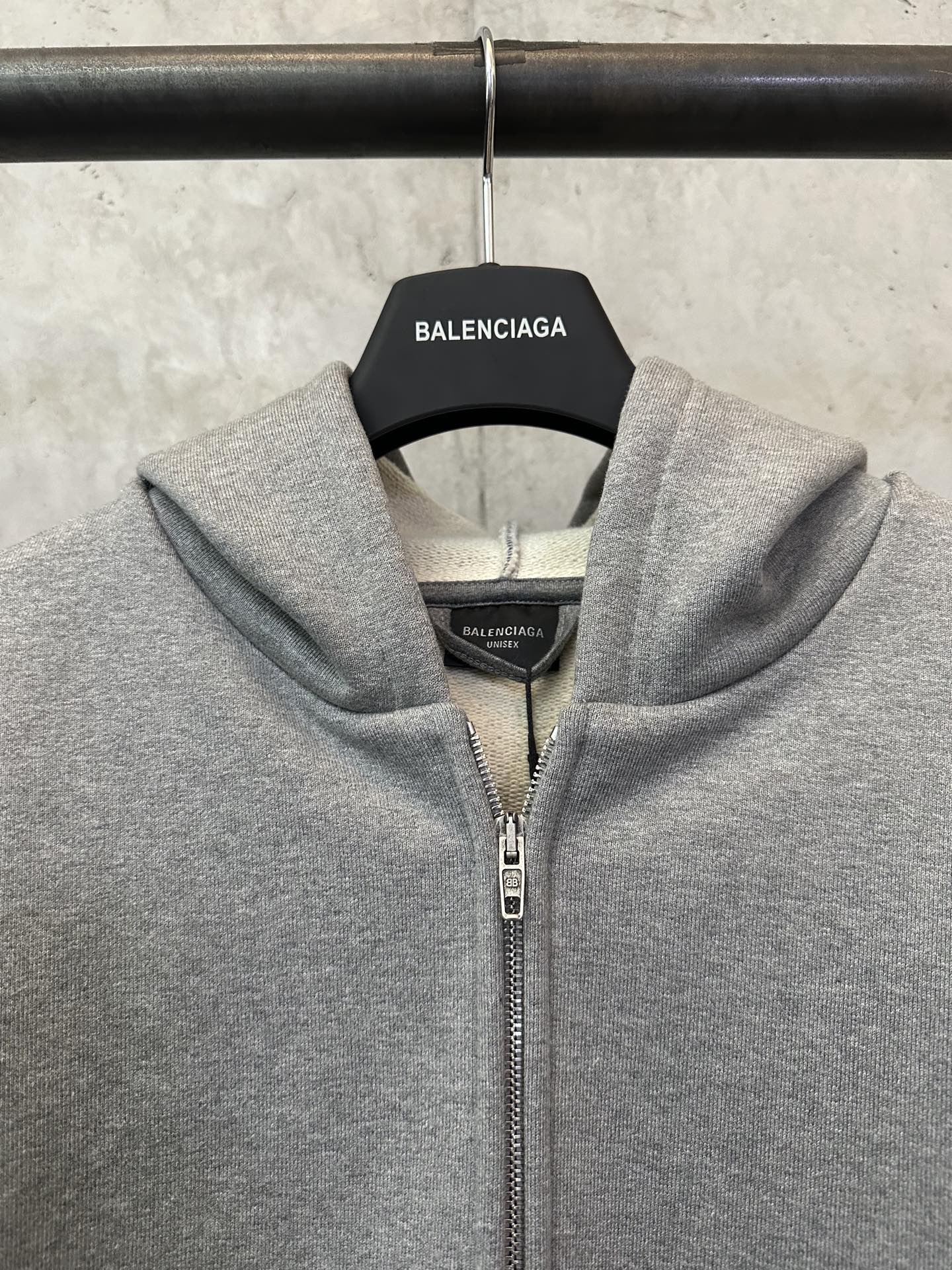 Balenciaga grey zip-up hoodie close-up at hood, collar, and zipper