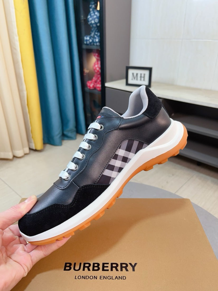 Burberry leather sneakers in dark navy/black with check panel and orange trim