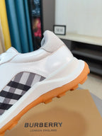 Burberry white sneakers with check side panel and orange rubber outsole edge