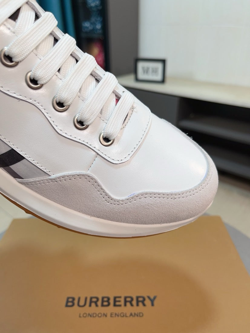 Burberry white leather sneaker upper close-up with lace eyelets and check stripe