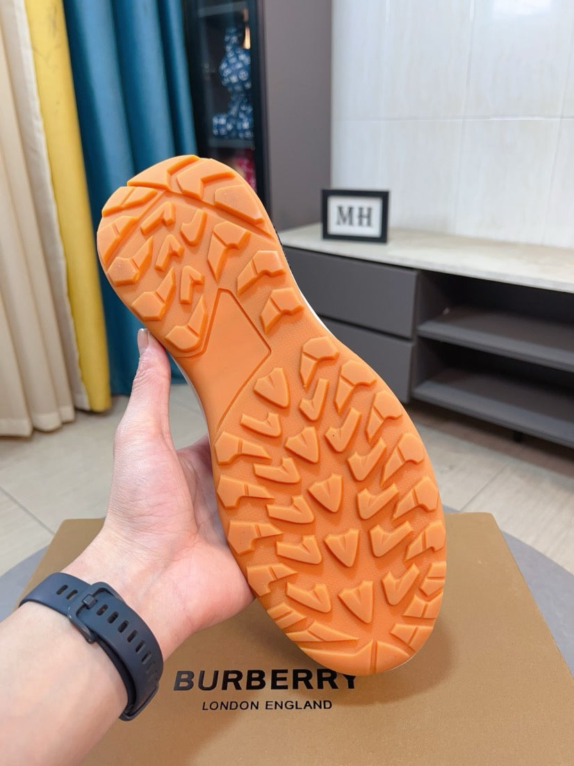Orange rubber outsole with tread pattern on sneaker bottom