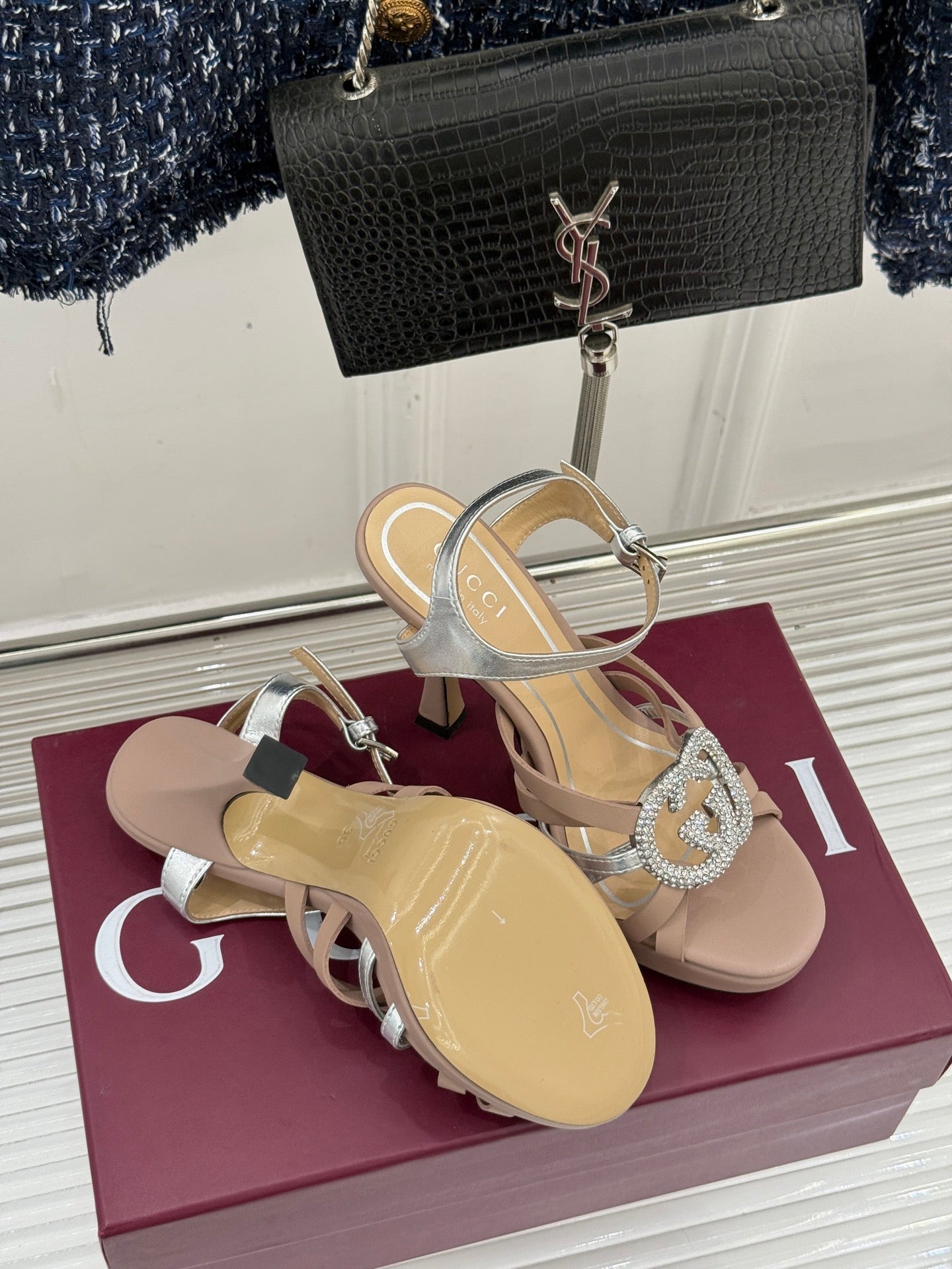 Gucci heeled sandals with silver straps, crystal-style heart buckle, and stiletto heel