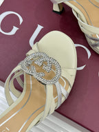 Gucci ladies sandal close-up: cream toe strap with rhinestone interlocking G buckle