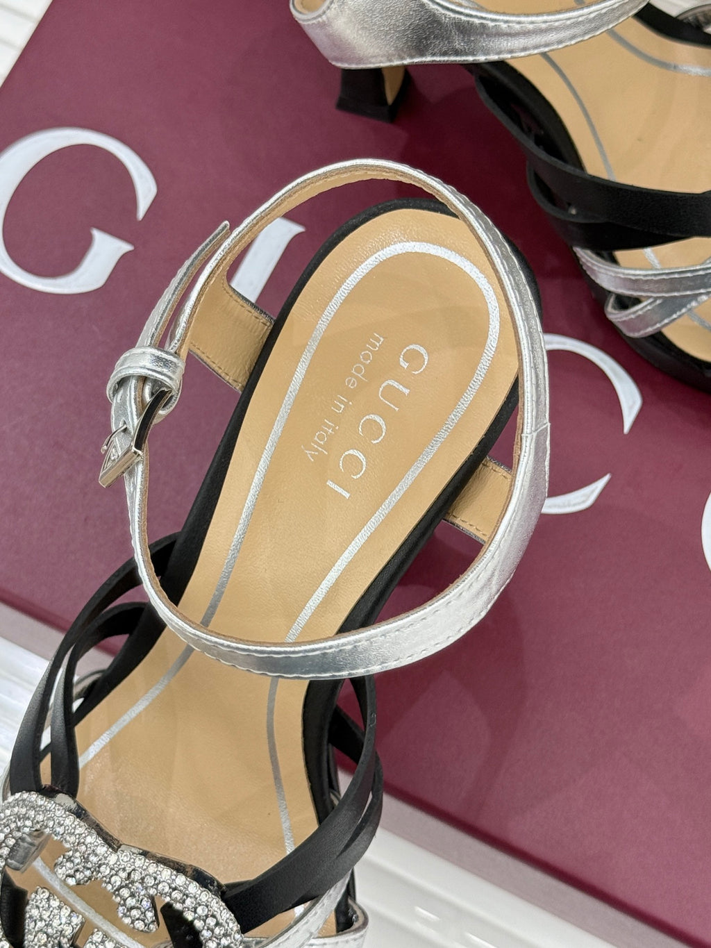Gucci heeled sandal with silver ankle strap and transparent sole detailing, on black base