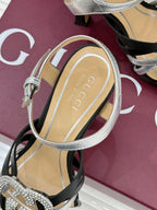 Gucci heeled sandal with silver ankle strap and transparent sole detailing, on black base
